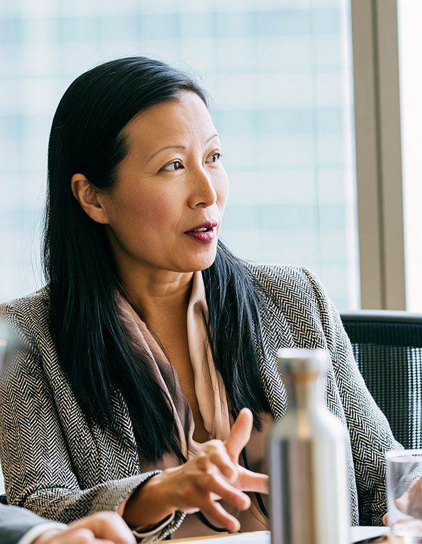 Senior leader engaged in discussion during a meeting.