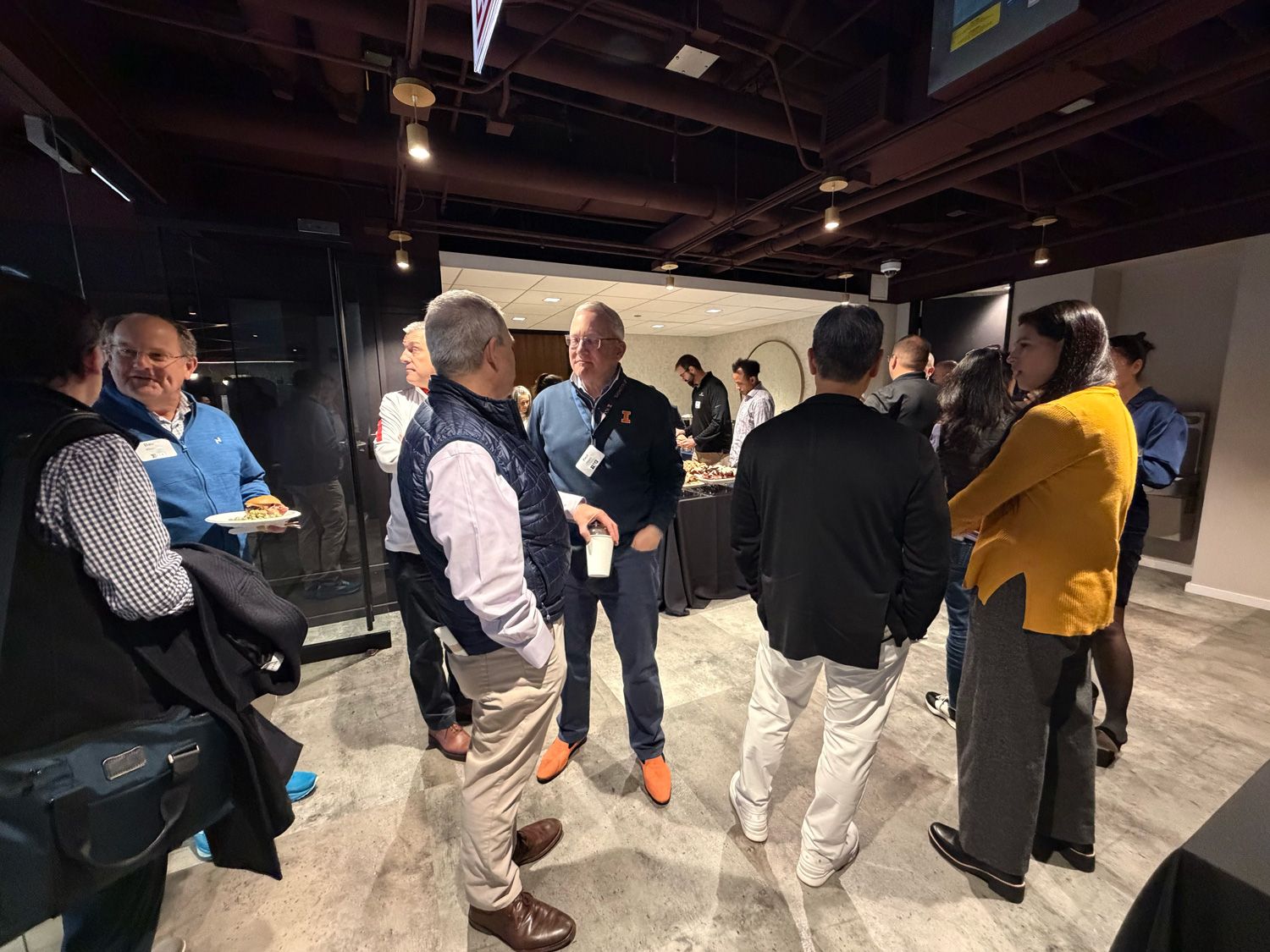 Investors and founders networking at a reception