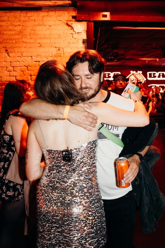 Singer Jeanie Marinella greets a fan with a hug - photo by Conner Yi